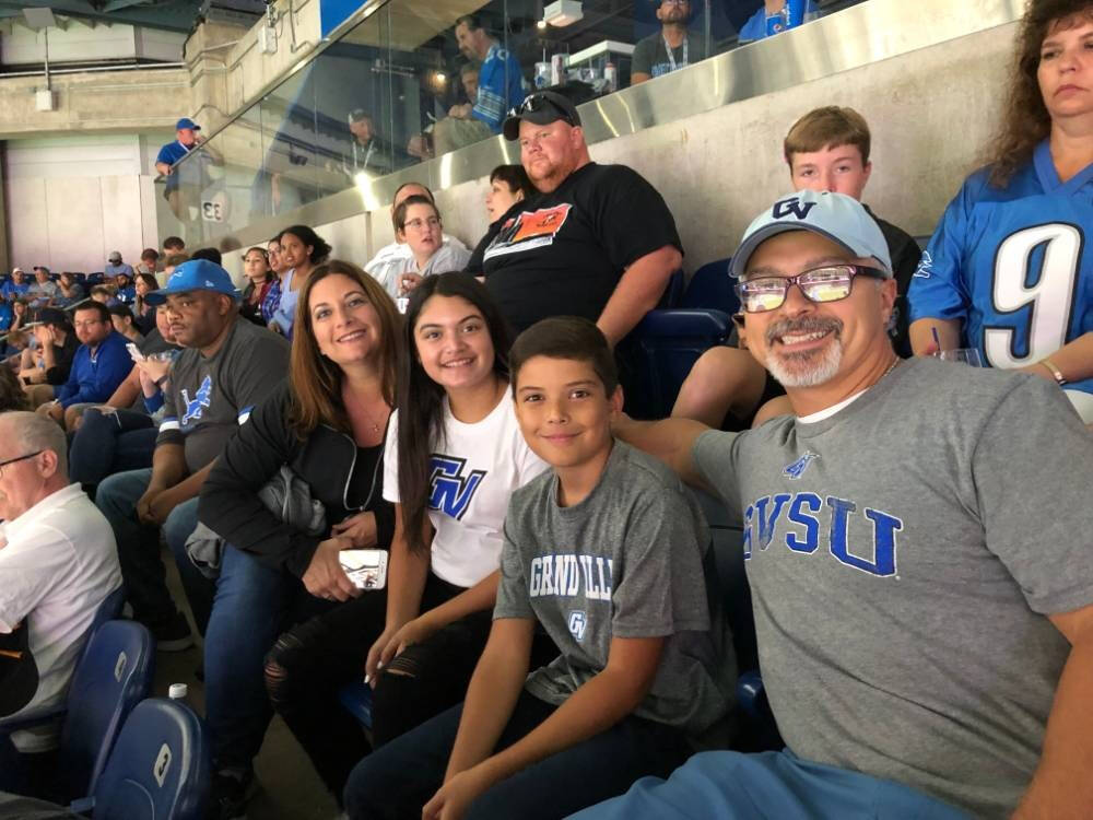 A family sitting in the stands at a Detroit Pistons game